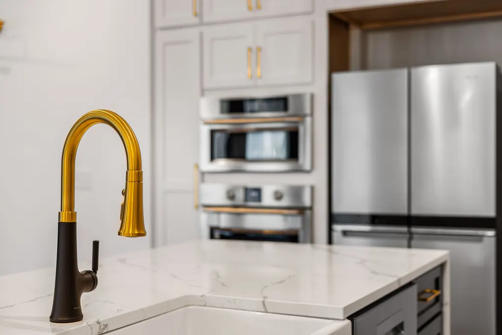 Quartz countertop and brass faucet detail